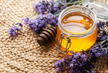 Jar with honey and fresh lavender flowers