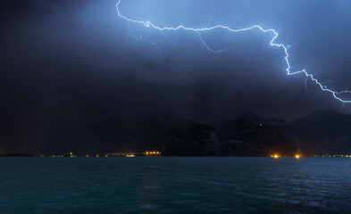 Naklejka na ściany i meble Lightning over mountains and Lake Lucerne. Switzerland. Europe. Storm.