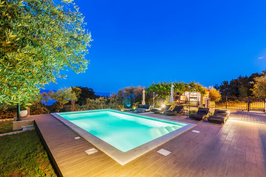 Illuminated pool on the summer terrace in the evening