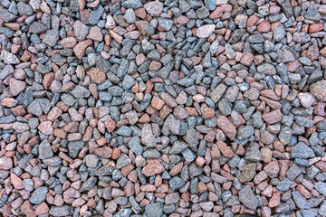 Natural crushed granite gravel as a background. Industrial design