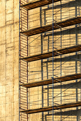 Scaffolding and the wall under construction. 