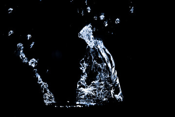 Splashing water on a black background. Water splashes on a black background. diffused water abstract