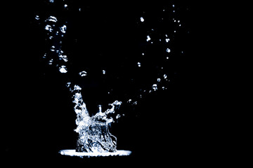 Splashing water on a black background. Water splashes on a black background. diffused water abstract