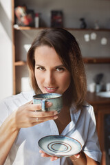portrait of woman with mug of coffee in her hands