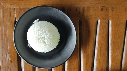 Jasmine rice in black dish on wooden table