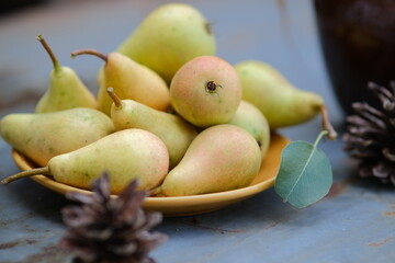 Yellow nrushi in a yellow plate. Still life of ripe pears. Fruit in a bowl