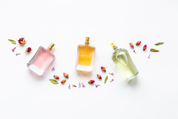 Floral fragrance - perfume bottles with flowers, top view - obrazy, fototapety, plakaty
