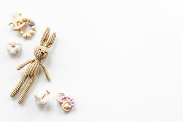 Knitted baby toy rabbit for newborn with wooden toys, top view