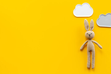 Knitted baby toy rabbit for newborn - background for baby shower