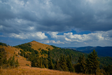 Naklejka na ściany i meble autumn September season mountain ridge nature photography landscape scenic view in dramatic cloudy weather time
