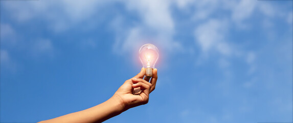 Hand holding light bulb,natural energy and love the world concept.	