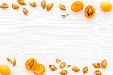 Dried apricot kernel with ripe apricot fruits, top view