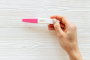 Pregnancy test in female hand. Morherhood and pregnancy concept