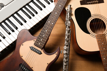 Set of different musical instruments on wooden background, closeup - obrazy, fototapety, plakaty