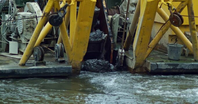 the working process of dredging the city canal. technical works on the water canal. equipment for deepening the bottom of rivers