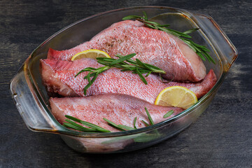 Ocean perch carcasses prepared for baking in glass baking dish