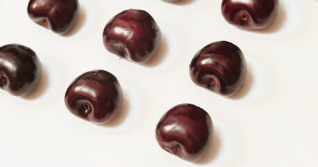 close up of cherries on white background
