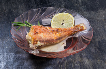 Ocean perch cooked in sour cream sauce on glass dish