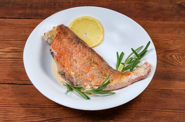 Redfish cooked in sour cream on dish on rustic table