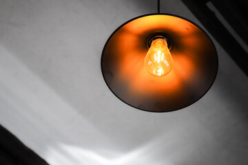Tungsten lamp mounted in a round lampshade