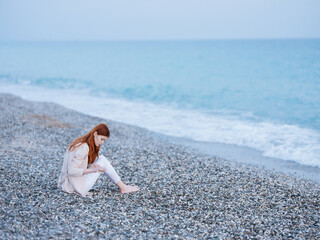 woman sitting by the ocean rest freedom romance nature