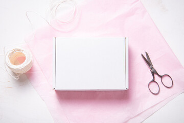 White Cardboard Carton box on pink tissue paper