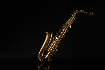 Beautiful saxophone on black background. Musical instrument