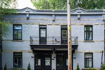 Colorful brick facades and typical Montreal architecture of houses located on Drolet street, in Plateau Mont Royal neighborhood