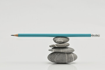 Balanced Writer concept. Pencil on Stack of pebbles