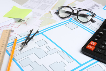 Office stationery and eyeglasses on cadastral maps of territory with buildings