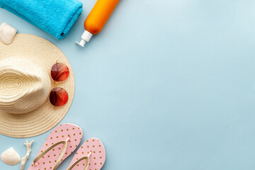Frame of beach accessories with sraw hat, sunglasses and flip flops
