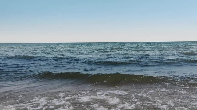 Small waves breaking on the shore. Shot 4K on the beach the Black Sea.