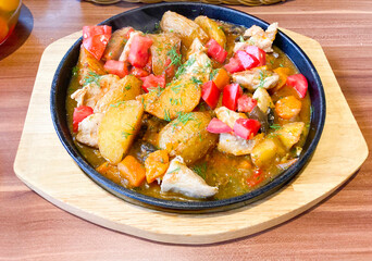 roast meat and vegetables in a frying pan