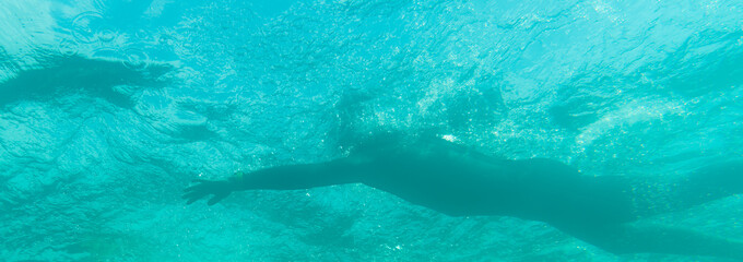 Triathlete swimming in a lake, underwater perspective