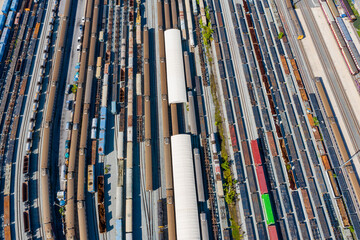 Obraz premium Aerial top view Passenger and freight trains on the railway station for transportation background. wagons with goods on railroad.
