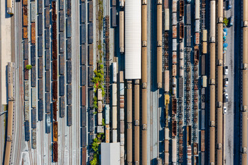 Aerial view of Passenger and railway wagons. Cargo trains. Train container cargo on the railway station for transportation background. wagons with goods on railroad.