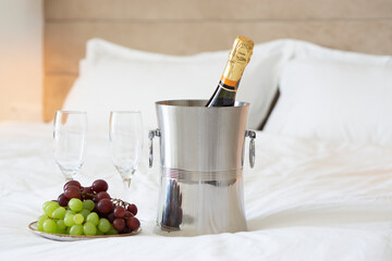 Luxury service at resort hotel  . champagne with delicious grape fruits on bed . Honeymoon and valentine day concept . Vacation  and tourist destination concept