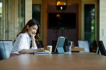 Asian Young Female using laptop computer at office. Student girl working at home. Work or study from home, freelance, business, lifestyle concept.