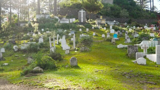 Cemetery with white tombstones, graves and crosses in the mountain province. Philippines, Luzon.