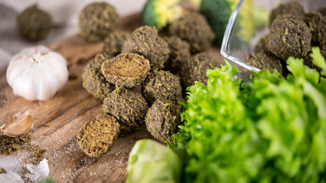 Vegetarian raw broccoli and greens meatballs on cutting board. Healthy homemade food.