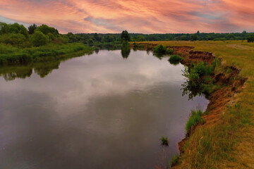 Beautiful sunset on the banks of the river. Picturesque view.