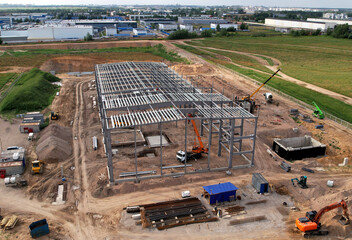 Construction of warehouse from metal structures. Industrial building on steel framing. Frame of...