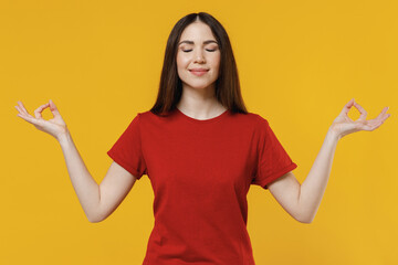 Spiritual tranquil young brunette woman 20s wears basic red t-shirt hold spreading hands in yoga om...