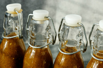Close-up of top of the glass swing top bottles with homemade Sriracha style chili sauce.