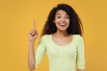 Insighted smart proactive african american young woman 20s wears green shirt hold index finger up...