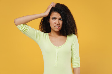 Aggrieved disturbed displeased african american young brunette woman 20s wear green shirt look...