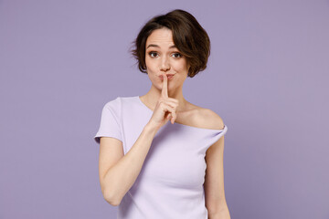 Young secret brunette woman 20s with bob haircut wear white t-shirt say hush be quiet with finger...