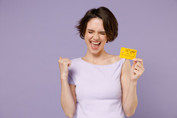 Young fun excited overjoyed happy rich brunette woman 20s with bob haircut in white t-shirt holding...