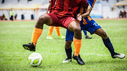 Soccer players action in the stadium during match