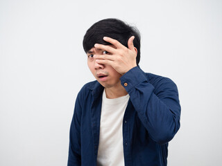 Asian man peeking through his fingers dont want to look something portrait white background